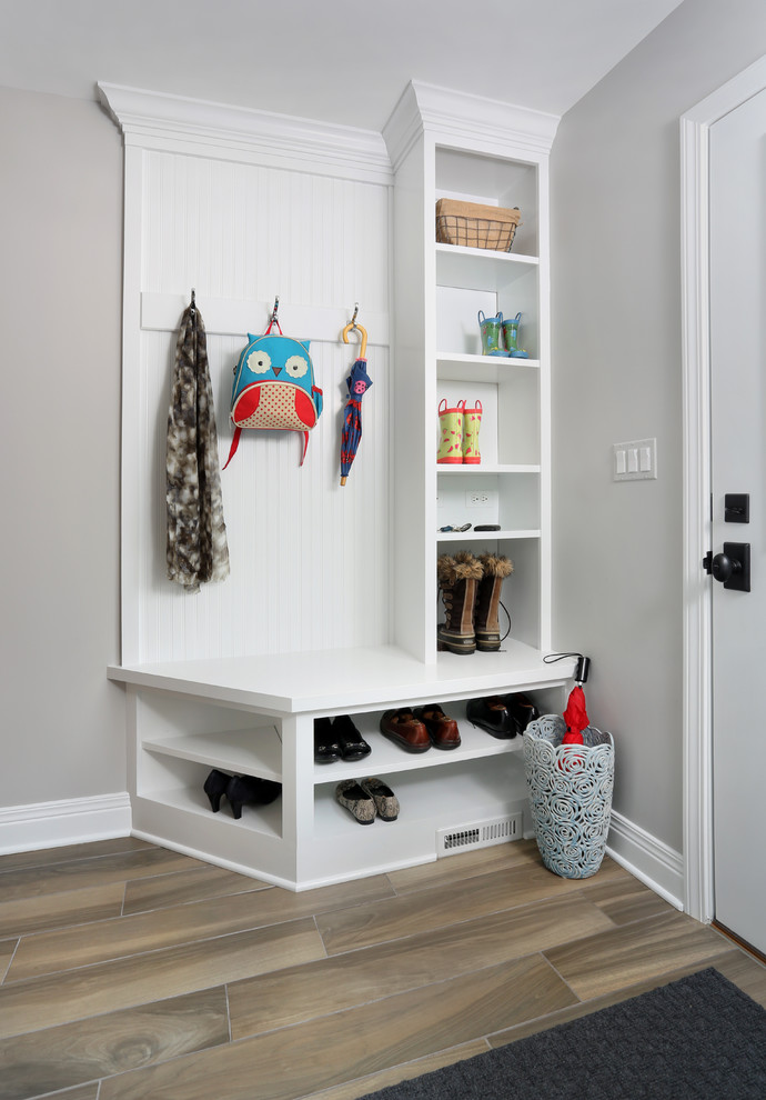 Mid-sized traditional mudroom in Chicago with grey walls and porcelain floors.