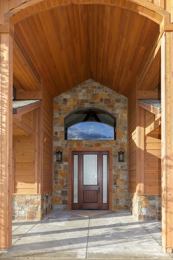 Large mountain style front door photo with a dark wood front door