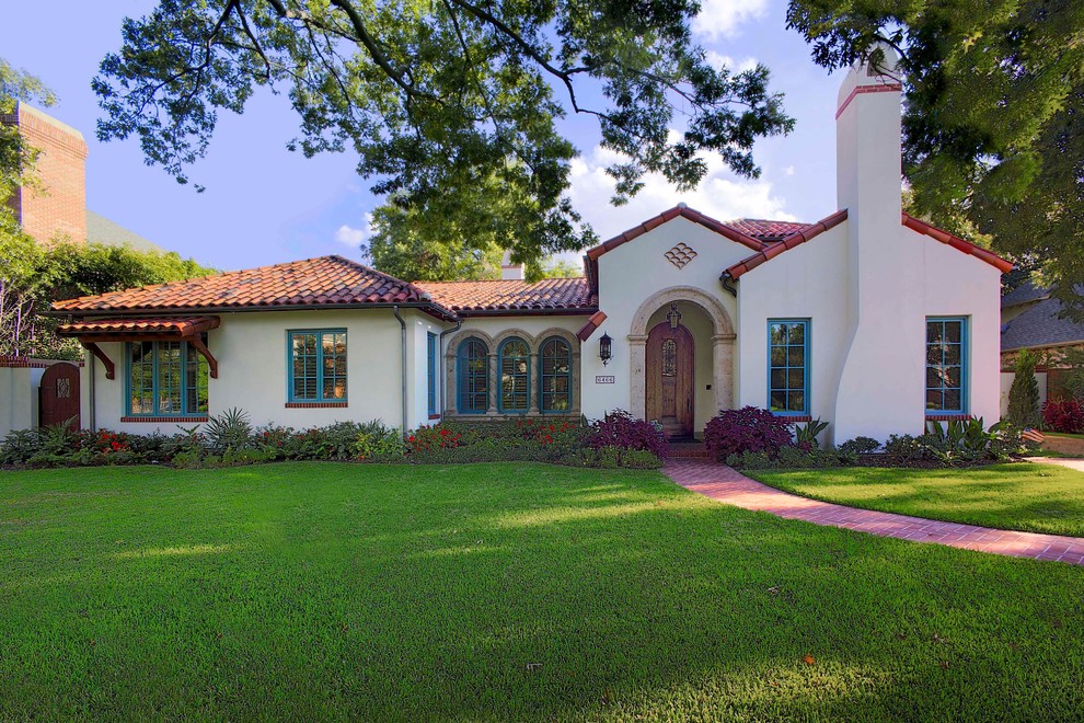 Photo of a mid-sized mediterranean one-storey stucco white exterior in Dallas with a hip roof.