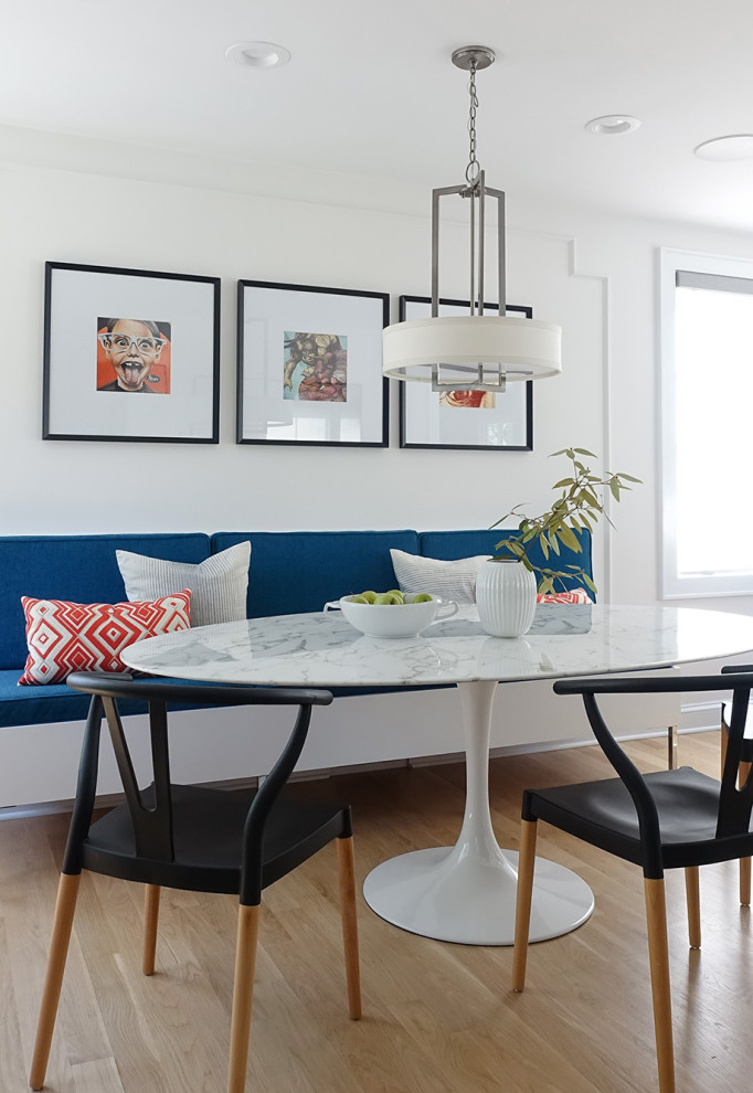 Mid-sized minimalist l-shaped light wood floor kitchen/dining room combo photo in New York with a double-bowl sink, gray cabinets, quartz countertops, white backsplash, marble backsplash, black appliances, no island and white countertops