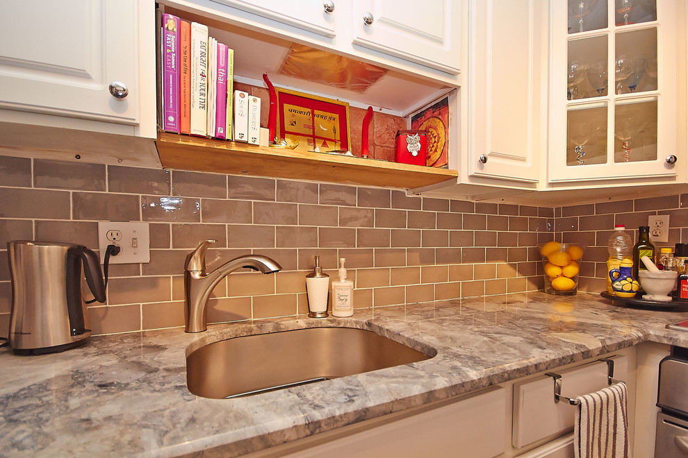 Inspiration for a small contemporary galley separate kitchen in DC Metro with an undermount sink, raised-panel cabinets, white cabinets, granite benchtops, beige splashback, subway tile splashback, stainless steel appliances, dark hardwood floors and with island.