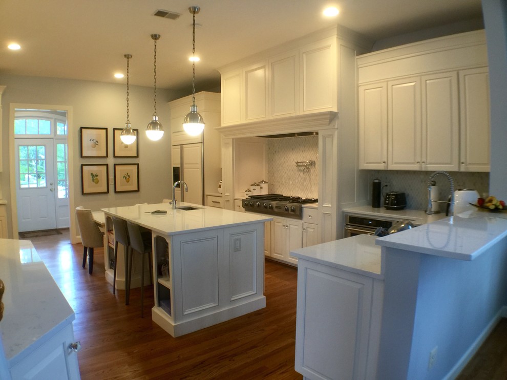 Large transitional u-shaped medium tone wood floor open concept kitchen photo in DC Metro with an undermount sink, raised-panel cabinets, white cabinets, quartzite countertops, stainless steel appliances and an island