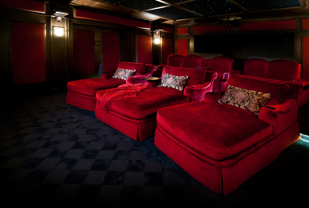 Design ideas for a mid-sized transitional enclosed home theatre in Vancouver with red walls, carpet, a projector screen and black floor.