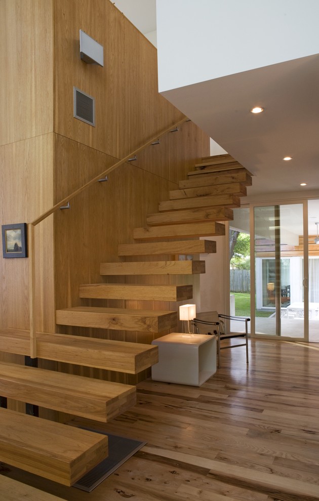 Inspiration for a modern wood floating staircase in Austin with open risers and wood railing.