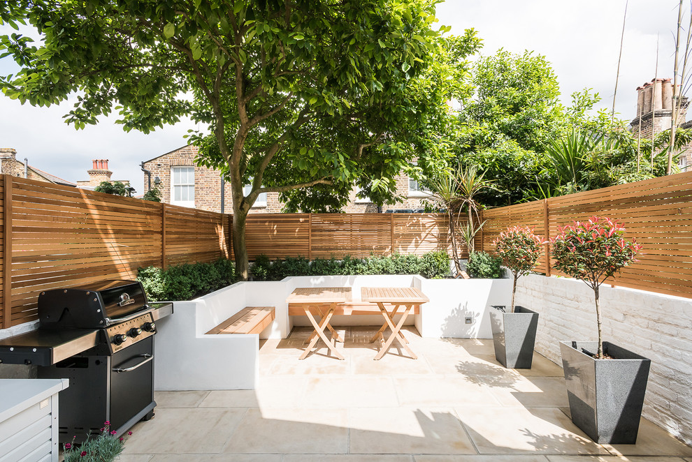 Inspiration for a large modern backyard patio in London.