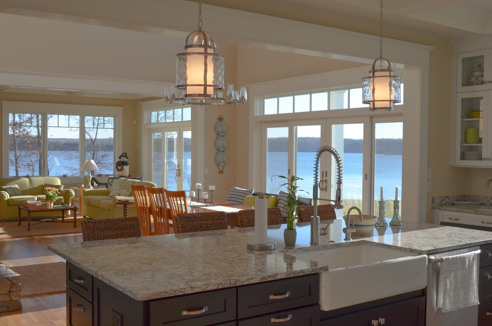 Design ideas for a large beach style single-wall eat-in kitchen in Other with a farmhouse sink, shaker cabinets, white cabinets, granite benchtops, blue splashback, glass tile splashback, stainless steel appliances, light hardwood floors and with island.