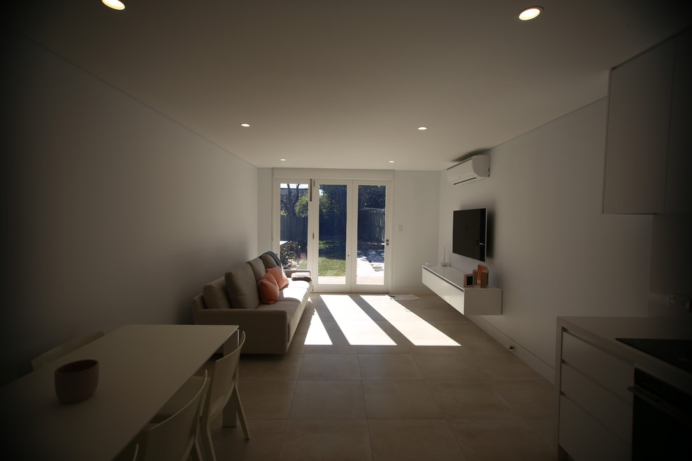 This is an example of a small modern formal open concept living room in Sydney with porcelain floors.
