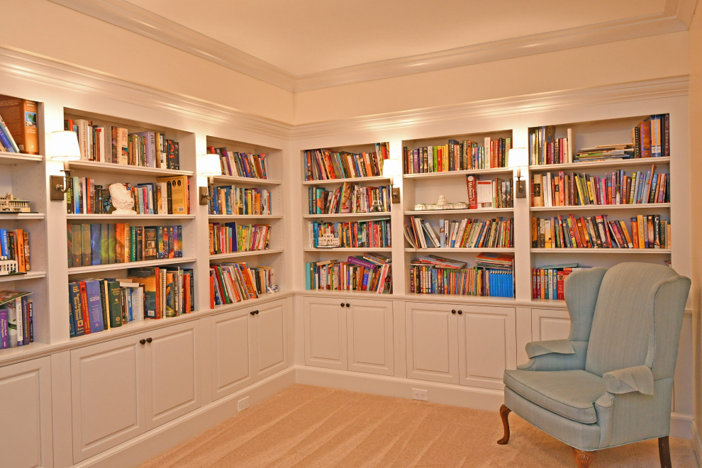Design ideas for a mid-sized traditional home office in Cleveland with a library, beige walls, carpet and beige floor.