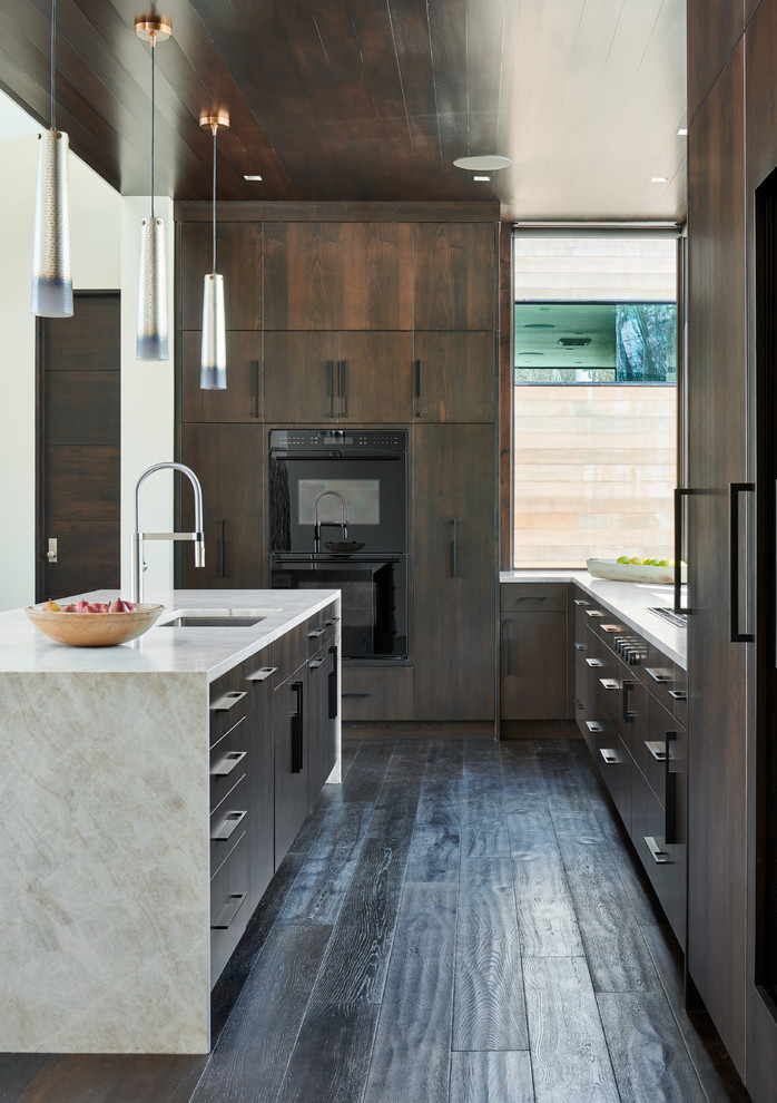 Design ideas for a mid-sized modern u-shaped open plan kitchen in Denver with an undermount sink, flat-panel cabinets, dark wood cabinets, dark hardwood floors, with island, brown floor, limestone benchtops, panelled appliances and white benchtop.