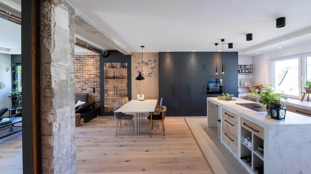 Photo of an industrial open plan kitchen in Other with flat-panel cabinets, medium wood cabinets, concrete worktops and all types of island.