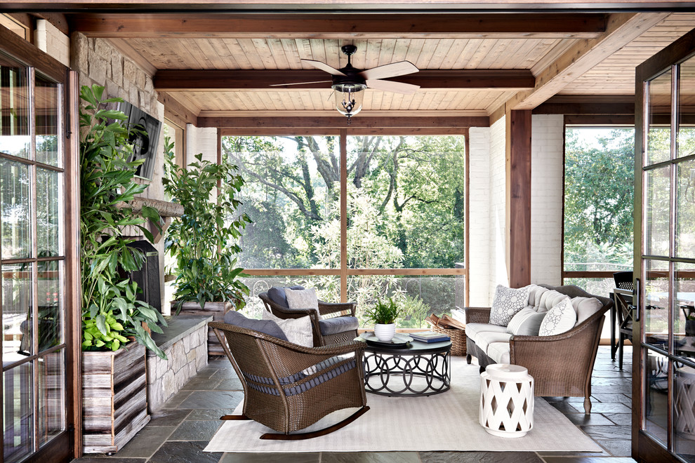 Mid-sized transitional backyard screened-in verandah in Nashville with natural stone pavers and a roof extension.