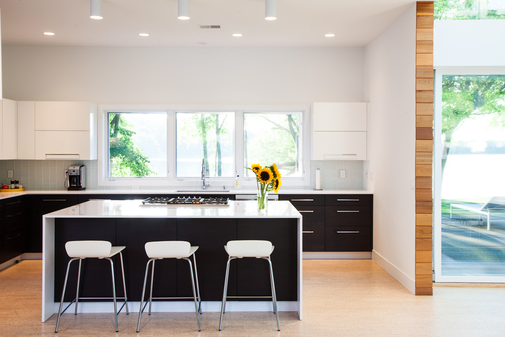 Inspiration for a contemporary kitchen in Grand Rapids with flat-panel cabinets, dark wood cabinets and white splashback.