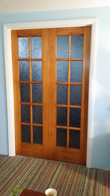 Front door - mid-sized transitional carpeted front door idea in Denver with blue walls and a glass front door