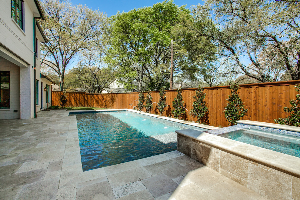 This is an example of a mid-sized transitional backyard rectangular lap pool in Dallas with a hot tub and tile.