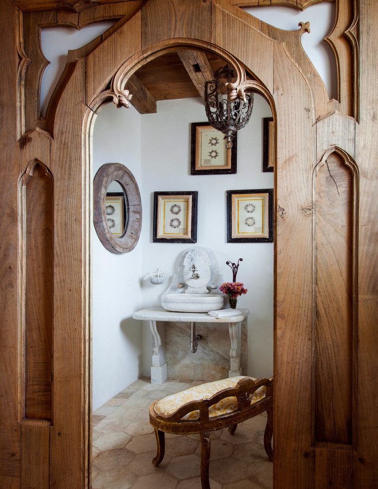 This is an example of a mediterranean powder room in Los Angeles.