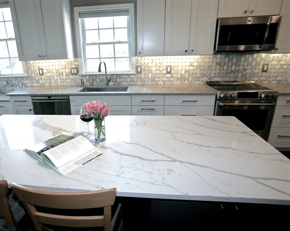 Open concept kitchen - large transitional l-shaped open concept kitchen idea with shaker cabinets, white cabinets and an island