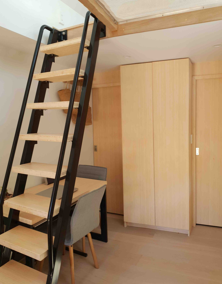 Photo of a small transitional wood straight staircase in Auckland with open risers and metal railing.