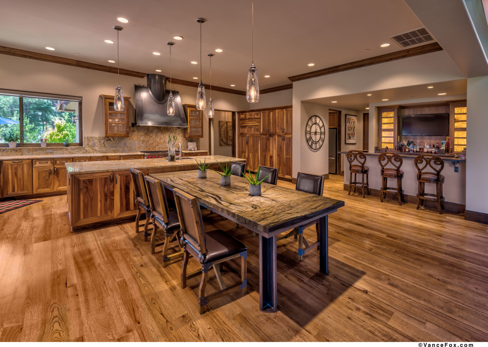 Mid-sized country single-wall seated home bar in Other with glass-front cabinets, medium wood cabinets, granite benchtops, brown splashback, brown benchtop, an undermount sink, timber splashback, medium hardwood floors and brown floor.