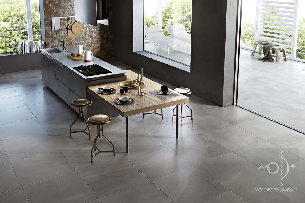 Design ideas for a contemporary open plan kitchen in Bologna with porcelain floors and with island.