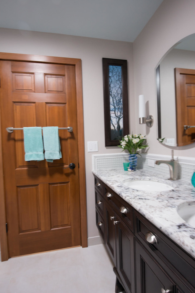 Example of a mid-sized transitional master bathroom design in Seattle with recessed-panel cabinets and dark wood cabinets