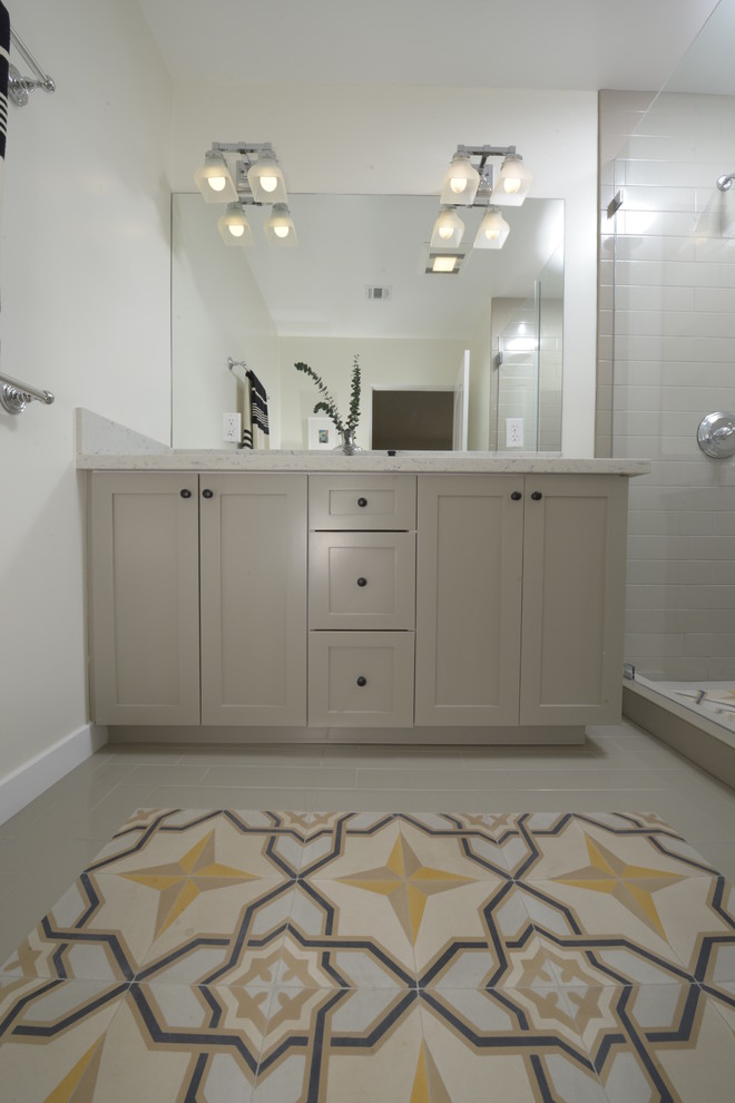 Design ideas for a mid-sized mediterranean master bathroom in Los Angeles with shaker cabinets, grey cabinets, engineered quartz benchtops, gray tile, cement tile, an alcove shower, a two-piece toilet, an undermount sink, white walls and concrete floors.