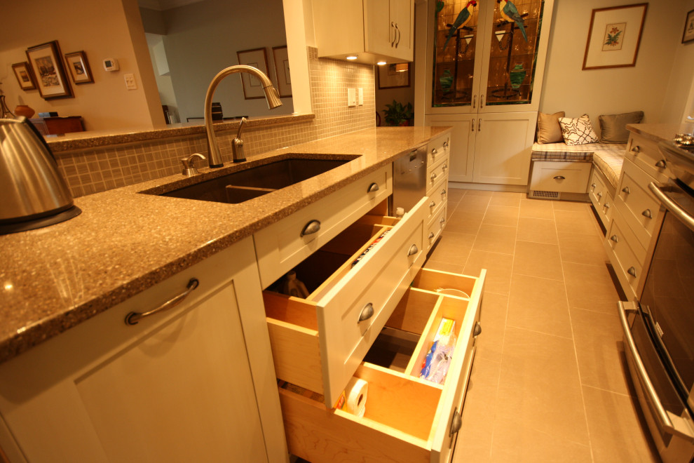 This is an example of a small transitional galley separate kitchen in Ottawa with an undermount sink, shaker cabinets, grey cabinets, quartz benchtops, beige splashback, mosaic tile splashback, stainless steel appliances, porcelain floors, no island, beige floor and grey benchtop.