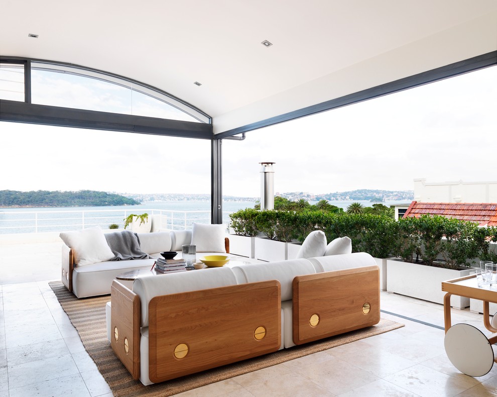 Large traditional open concept family room in Sydney with white walls and ceramic floors.