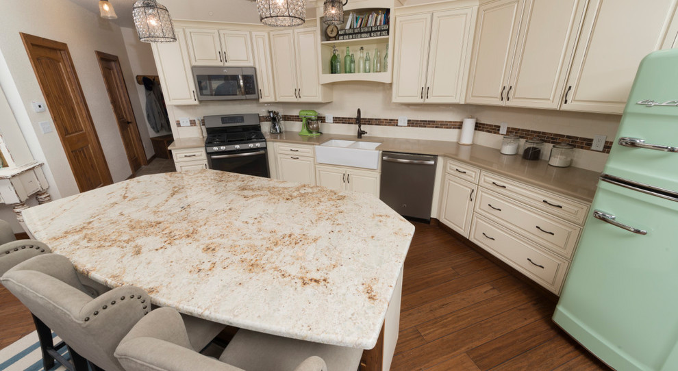 Design ideas for a mid-sized transitional u-shaped open plan kitchen in Denver with a farmhouse sink, raised-panel cabinets, beige cabinets, granite benchtops, beige splashback, ceramic splashback, stainless steel appliances, dark hardwood floors, with island and brown floor.