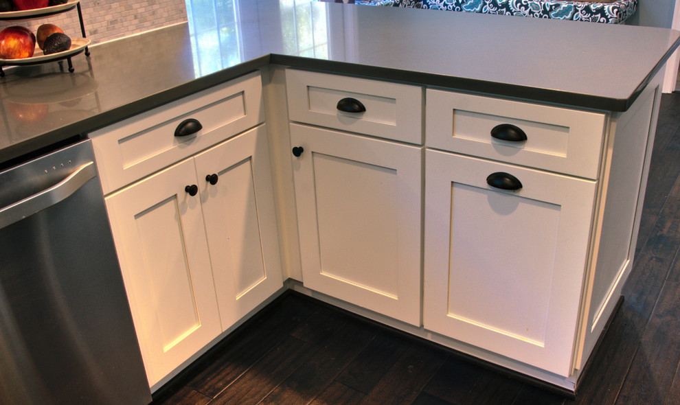 Inspiration for a mid-sized transitional u-shaped dark wood floor and brown floor kitchen remodel in DC Metro with an undermount sink, shaker cabinets, white cabinets, quartz countertops, gray backsplash, matchstick tile backsplash, stainless steel appliances and a peninsula