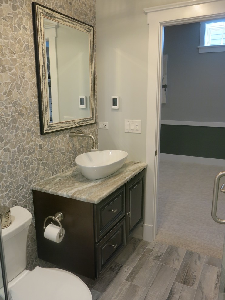 Photo of a transitional bathroom in Chicago with dark wood cabinets, an alcove shower, a two-piece toilet, white tile, pebble tile, porcelain floors, a vessel sink and granite benchtops.