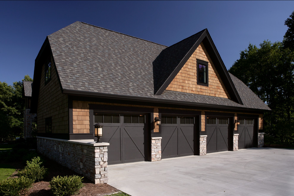 Photo of a large traditional detached four-car garage in Grand Rapids.