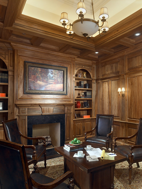 Mid-sized traditional study room in Chicago with brown walls, a standard fireplace, a wood fireplace surround, vaulted and panelled walls.
