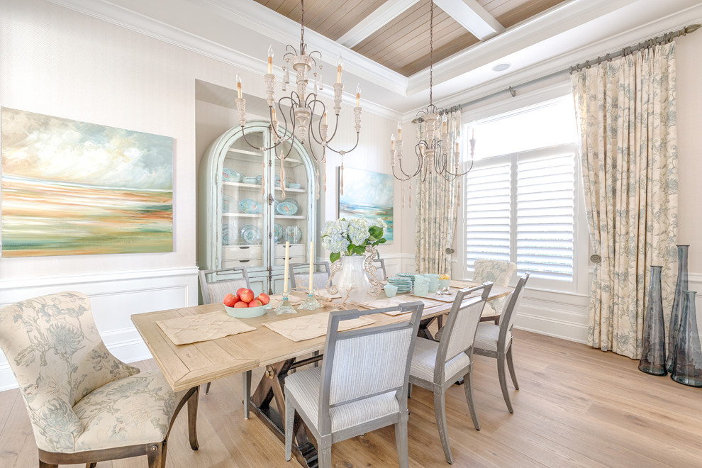 Large beach style dining room in Miami with medium hardwood floors, beige walls and brown floor.