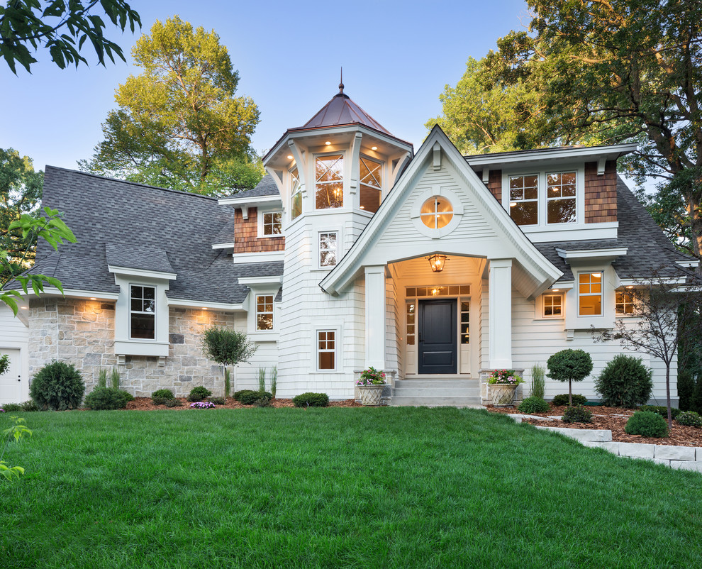Design ideas for a traditional two-storey white exterior in Minneapolis with a gable roof.