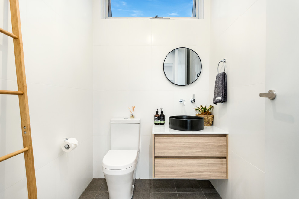 Design ideas for a small contemporary powder room in Sydney with flat-panel cabinets, a one-piece toilet, white tile, porcelain tile, white walls, ceramic floors, engineered quartz benchtops, grey floor and white benchtops.