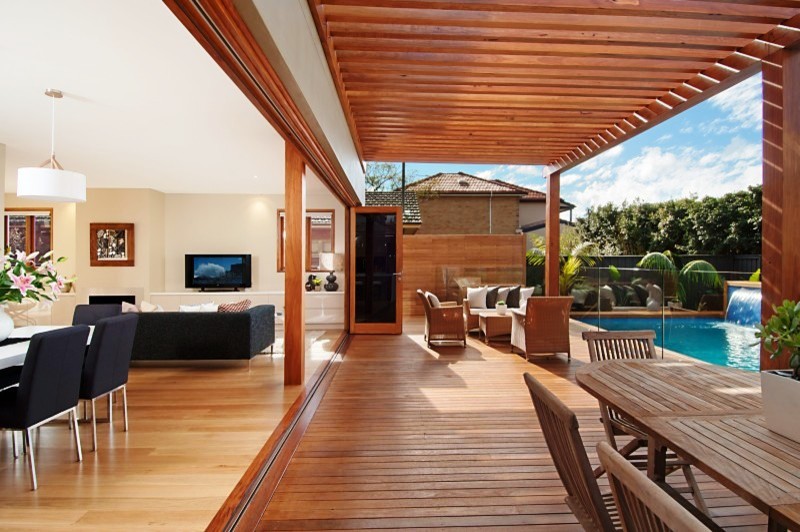 Photo of an expansive contemporary backyard verandah in Sydney with an outdoor kitchen, decking and a pergola.