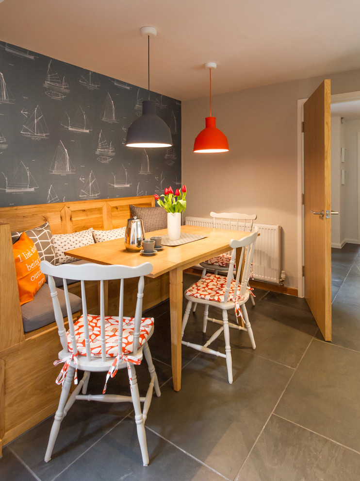 Photo of a beach style dining room in Other with grey walls and slate floors.
