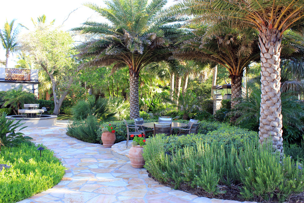 Design ideas for a tropical garden in Tampa with a water feature.