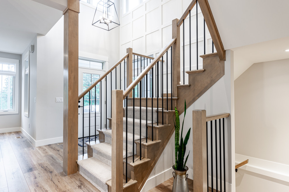 Inspiration for a mid-sized transitional wooden u-shaped wood railing and wall paneling staircase remodel in Toronto with wooden risers