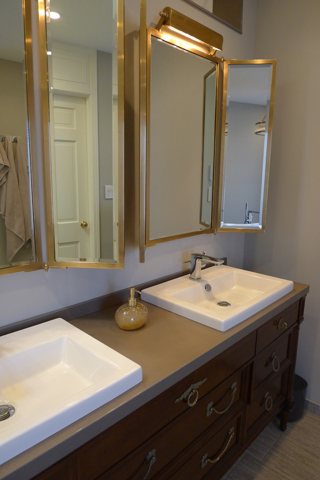 Inspiration for a large transitional master gray tile and porcelain tile porcelain tile freestanding bathtub remodel in Indianapolis with a drop-in sink, furniture-like cabinets, dark wood cabinets, solid surface countertops, a one-piece toilet and gray walls