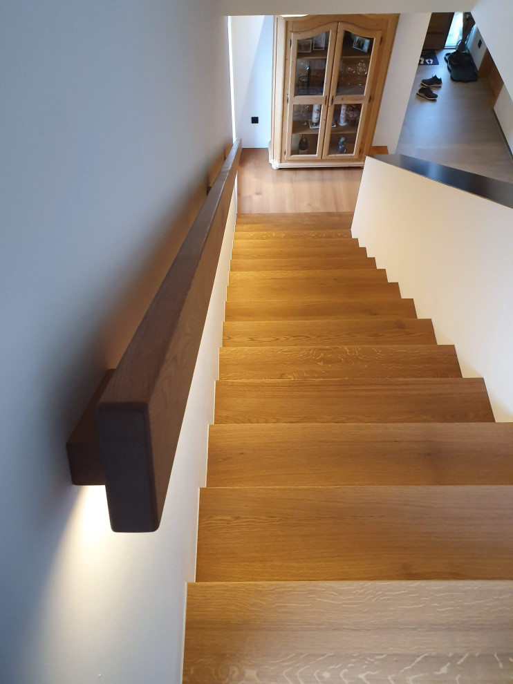 Inspiration for a mid-sized contemporary wood straight staircase in Munich with wood risers and wood railing.