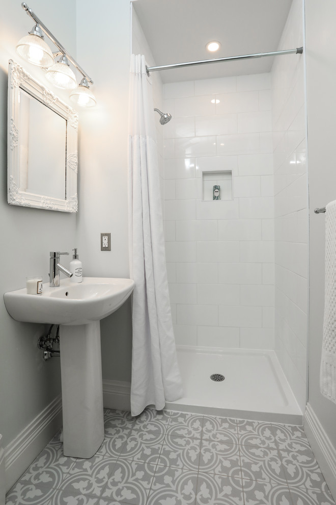 Inspiration for a mid-sized transitional 3/4 white tile gray floor alcove shower remodel with a one-piece toilet, white walls and a pedestal sink