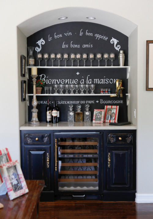 Wine cellar - small traditional medium tone wood floor wine cellar idea in Other with display racks