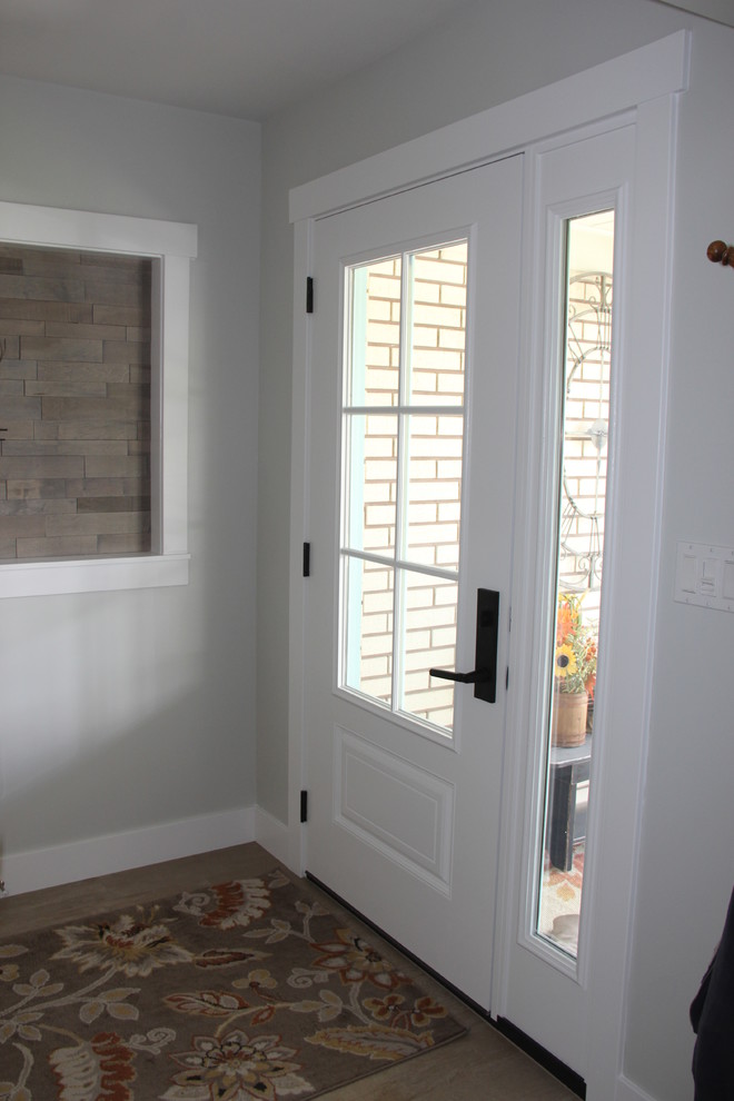 Mid-sized transitional porcelain tile and brown floor front door photo with gray walls and a white front door