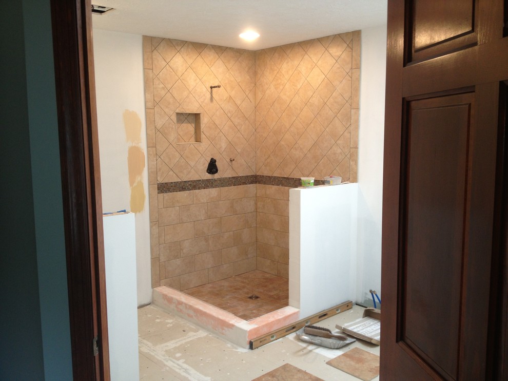 Photo of a large traditional master bathroom in Other with shaker cabinets, dark wood cabinets, granite benchtops, beige tile, porcelain tile, a corner shower, a two-piece toilet, an undermount sink, yellow walls and porcelain floors.