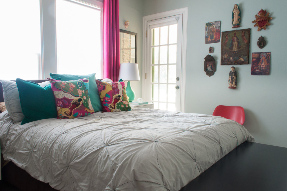 Photo of an eclectic bedroom in Dallas with blue walls.