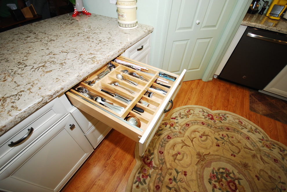 Example of a transitional kitchen design with flat-panel cabinets and white cabinets