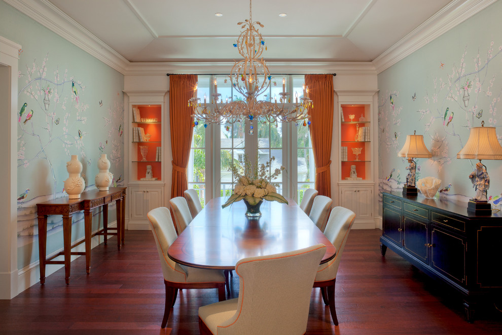 Tropical dining room in Miami with multi-coloured walls and dark hardwood floors.