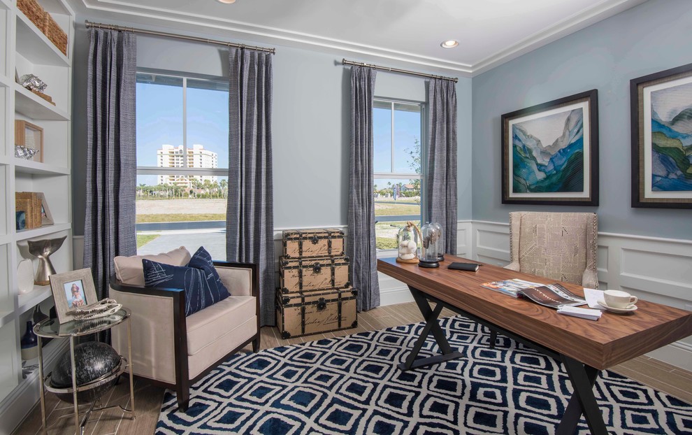 Beach style home office in Orlando with blue walls and decorative wall panelling.