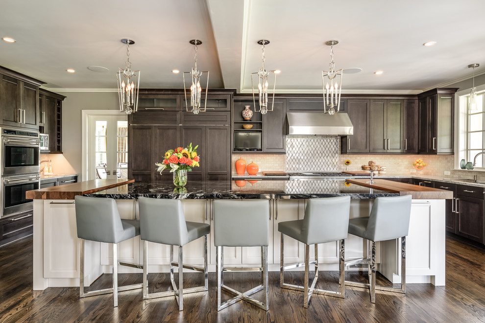 Large transitional u-shaped dark wood floor and brown floor eat-in kitchen photo in DC Metro with a double-bowl sink, shaker cabinets, dark wood cabinets, granite countertops, stone tile backsplash, stainless steel appliances, an island and beige backsplash
